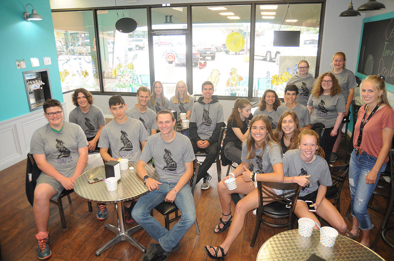 Decked out in their exclusive T-shirts, Sequim High’s “Wolves of the Week” enjoy a bit of frozen yogurt at Sweet Spot last week. The prep athletes from various Sequim sports received the honor through a partnership between Sequim High School and Castell Insurance that recognizes local prep student-athletes and helps raise funds for the SHS athletic department. This year’s Wolves of the Week include, by season and sport: Fall (2018) — Riley Cowan, football; Tayler Breckenridge, volleyball; Murray Bingham, cross country; Sonja Govertsen, swimming; Blake Wiker, tennis; Olivia Hare, soccer; Riley Pyeatt, cross country; Taig Wiker, football; Kalli Wiker, volleyball; Mia Coffman, swimming. Winter (2018-2019) — Jayla Julmist, basketball; Porter Funston, bowling; Nate Despain, basketball; Zachery Koch, wrestling; Liam Payne, swimming; Hope Glasser, basketball, Madison McKeown, bowling; Noah Eveland, wrestling; Michael Mattern-Hall, swimming; Kalli Wiker, basketball; Melissa Porter, basketball. (Spring 2019) — Darren Salazar, track and field; Ryan Tolberd, soccer; Eden Johnson, tennis; Johnnie Young, baseball; Paul Jacobsen, golf; LeeAnn Raney, fastpitch; Silas Thomas, baseball; Mathys Tanche, soccer; Jessica Dietzman and Kalli Wiker, tennis; Alec Shingleton, track and field. Sequim Gazette photo by Michael Dashiell