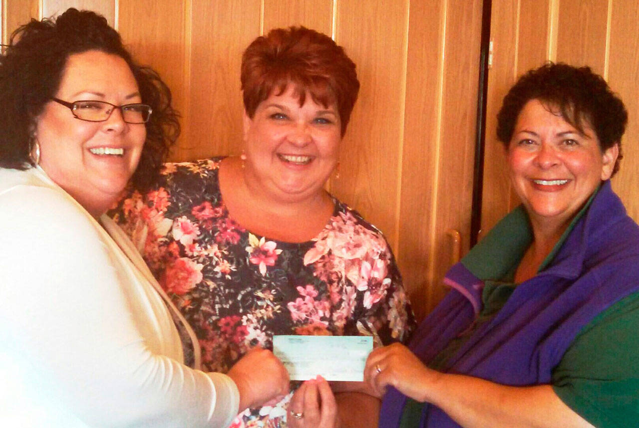 Celebrating a recent donation from WeDo Fudge to the Sequim Irrigation Festival are, from left, festival director Deon Kapetan, kickoff dinner/auction organizer Robin Bookter and Christina Norman of WeDo Fudge. Submitted photo