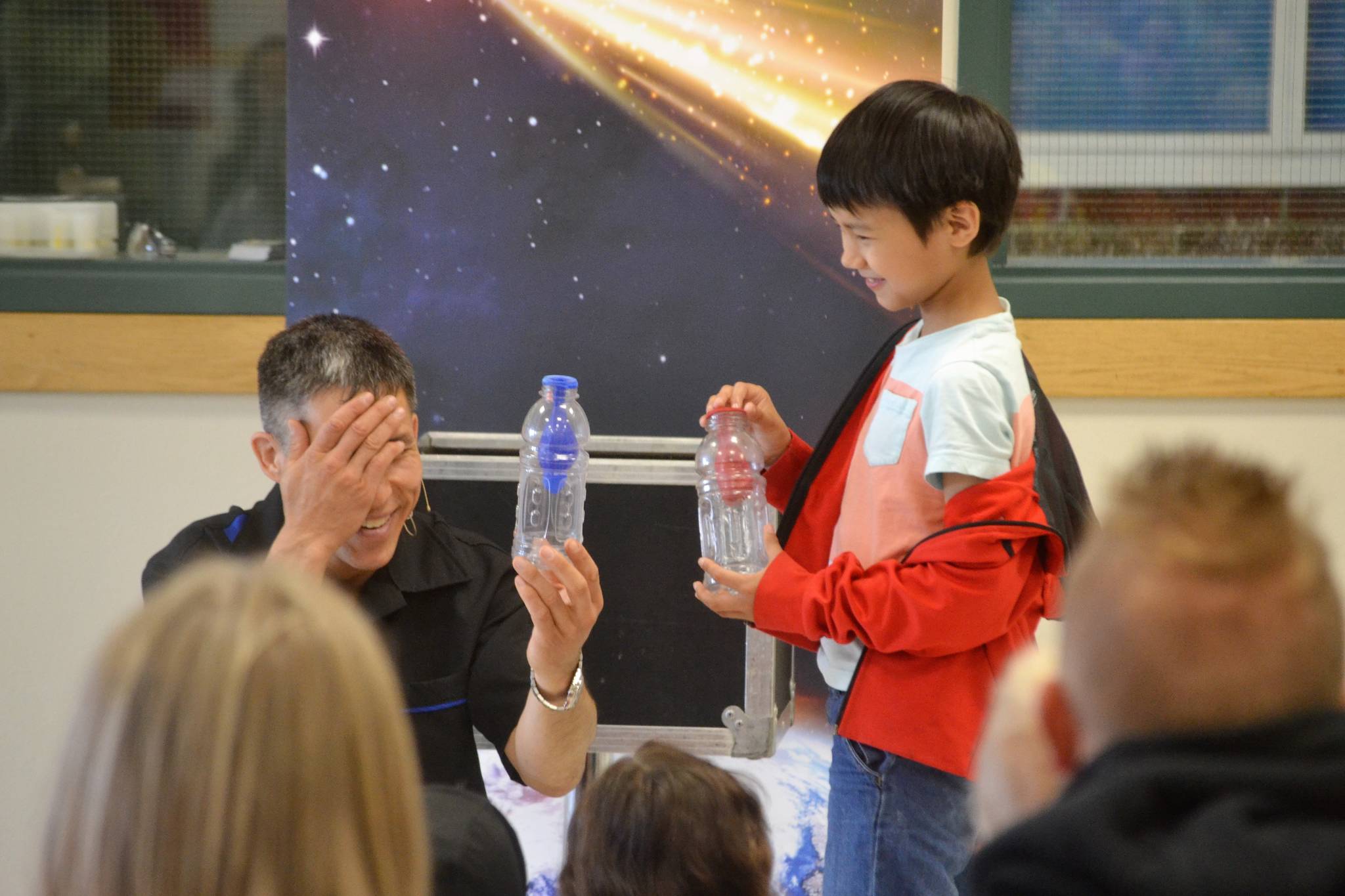Sequim’s Mason Blake receives a lesson on air pressure and how air travels from magician Jeff Evans during the North Olympic Library System’s Summer Reading Program on June 22. The program continues in Sequim on June 29 with Storytime at the Sequim Farmers Market. Sequim Gazette photo by Matthew Nash