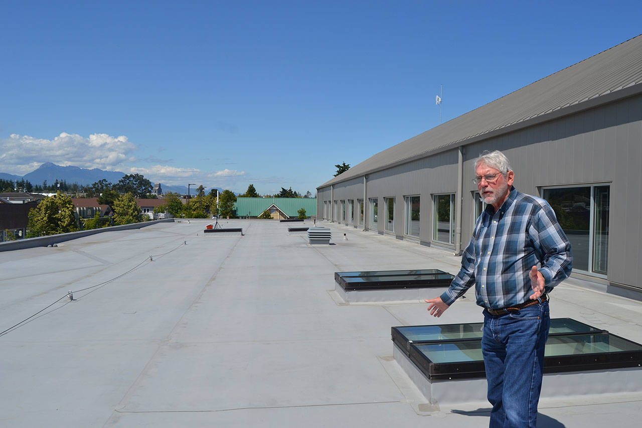 David Garlington, Sequim public works director, shows where 150 solar panels will be placed on the Sequim Civic Center’s roof tentatively sometime this year. In June, Sequim city councilors committed to paying for the panels in an effort to promote solar energy. Sequim Gazette photo by Matthew Nash