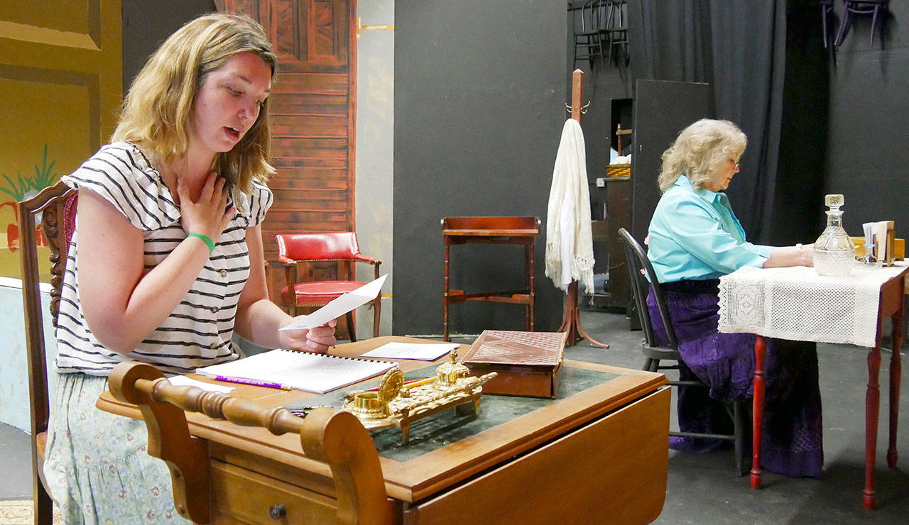 Kait Saffold, left, and Sharon DelaBarre reading through the letters they transcribed by hand from the script on a set under construction. Photo courtesy of Olympic Theatre Arts