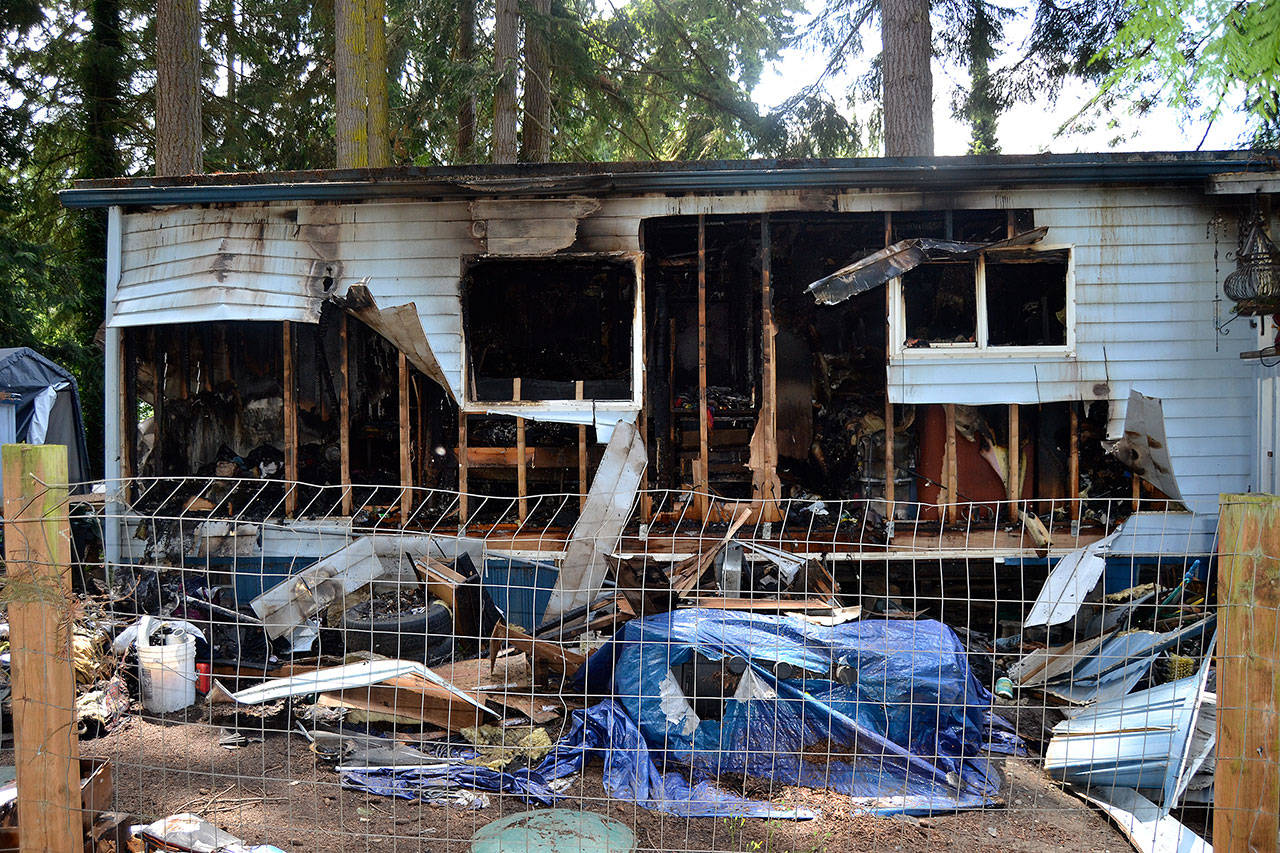 Fire crews continue to investigate a mobile home fire on July 4 that displaced three people in Dungeness Meadows. Officials with Clallam County Fire District 3 said an older laptop may have started the fire, which spread to the attic due to large amounts of items in the home. Sequim Gazette photo by Matthew Nash
