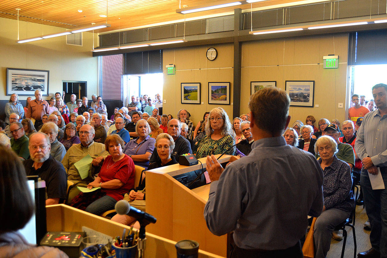 Barry Berezowsky, Sequim director of community development, addresses a crowd of more than 150 people on July 8 during a Sequim city council meeting, saying that there’s no proposal before city staff about the much talked about medication-assisted addiction treatment (MAT) facility. He said if a proposal does come in, it’ll will go before the Planning Commission. Sequim Gazette photo by Matthew Nash