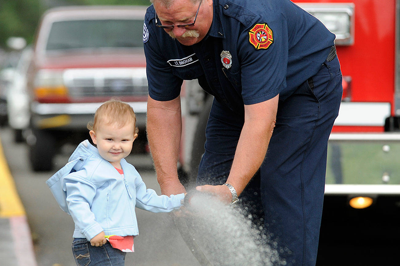 Library, firefighters help spray summer rain away at storytime