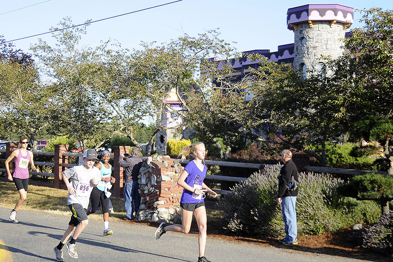Participants of the 2017 Valley of the Trolls race past Troll Haven in Gardiner. Sequim Gazette file photo by Michael Dashiell.