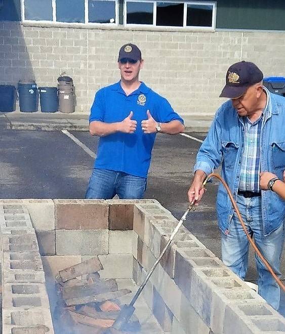 Ed Ebling and Lang Hadley ready a fire for the Rotary Club of Sequim’s annual Salmon Bake. The event returns noon-4 p.m. Sunday, Aug. 11, at the Sequim Boys & Girls Club. Submitted photo