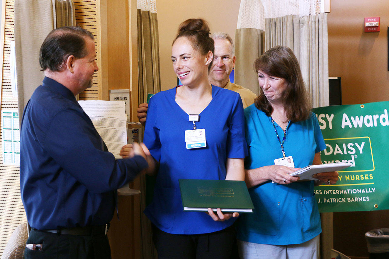 Pictured are, from left, chief nursing officer Ralph Parker, Katie Sayles, nursing supervisor/infusion services Julie Larson, and (in back), Dean Putt, director of Olympic Medical Cancer Center. Submitted photo
