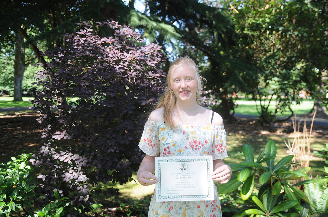 Hannah Gloor accepts a certificate from the Sequim Prairie Garden Club at Pioneer Memorial Park earlier this week. Gloor is considering a career involving architecture and botany. Sequim Gazette photo by Michael Dashiell