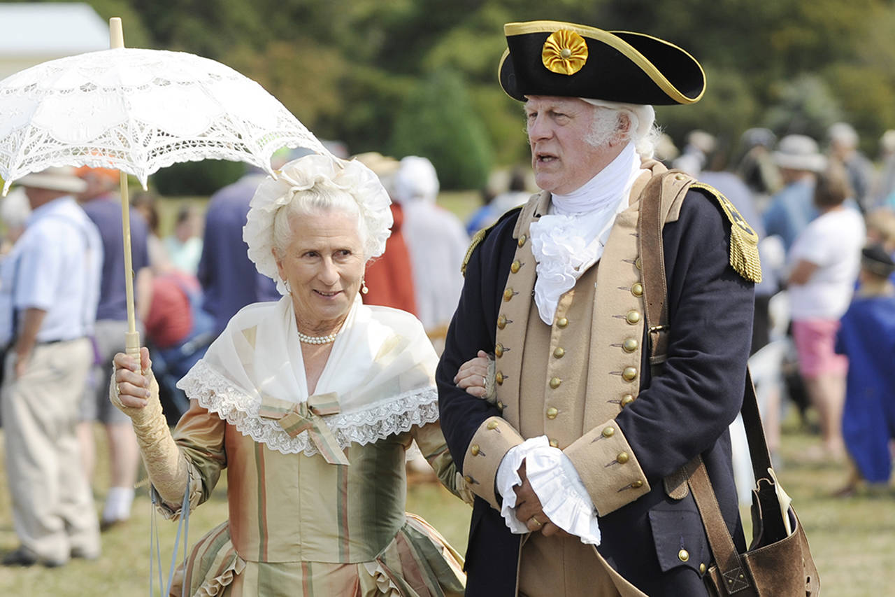 Vern Frykholm, right, walks across the 2018 Colonial Festival portraying George Washington alongside Jane Ritchey, left, portraying Martha Washington. Sequim Gazette file photo by Michael Dashiell