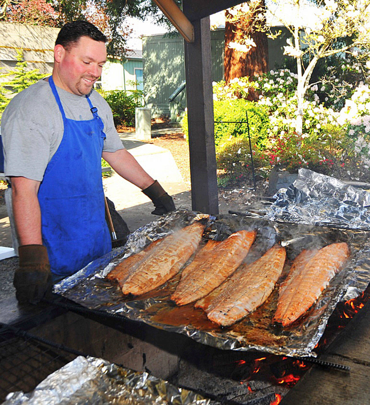 A Rotary Club member prepares wild salmon for guests. Photo courtesy of Rotary Club of Sequim