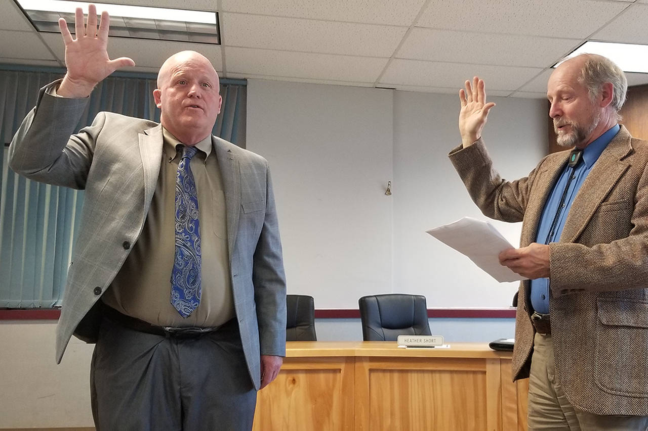 Rob Clark is officially sworn in as the interim superintendent of the Sequim School District by Judge Brian Coughenour at the Aug. 5 school board meeting. Sequim Gazette photo by Conor Dowley.