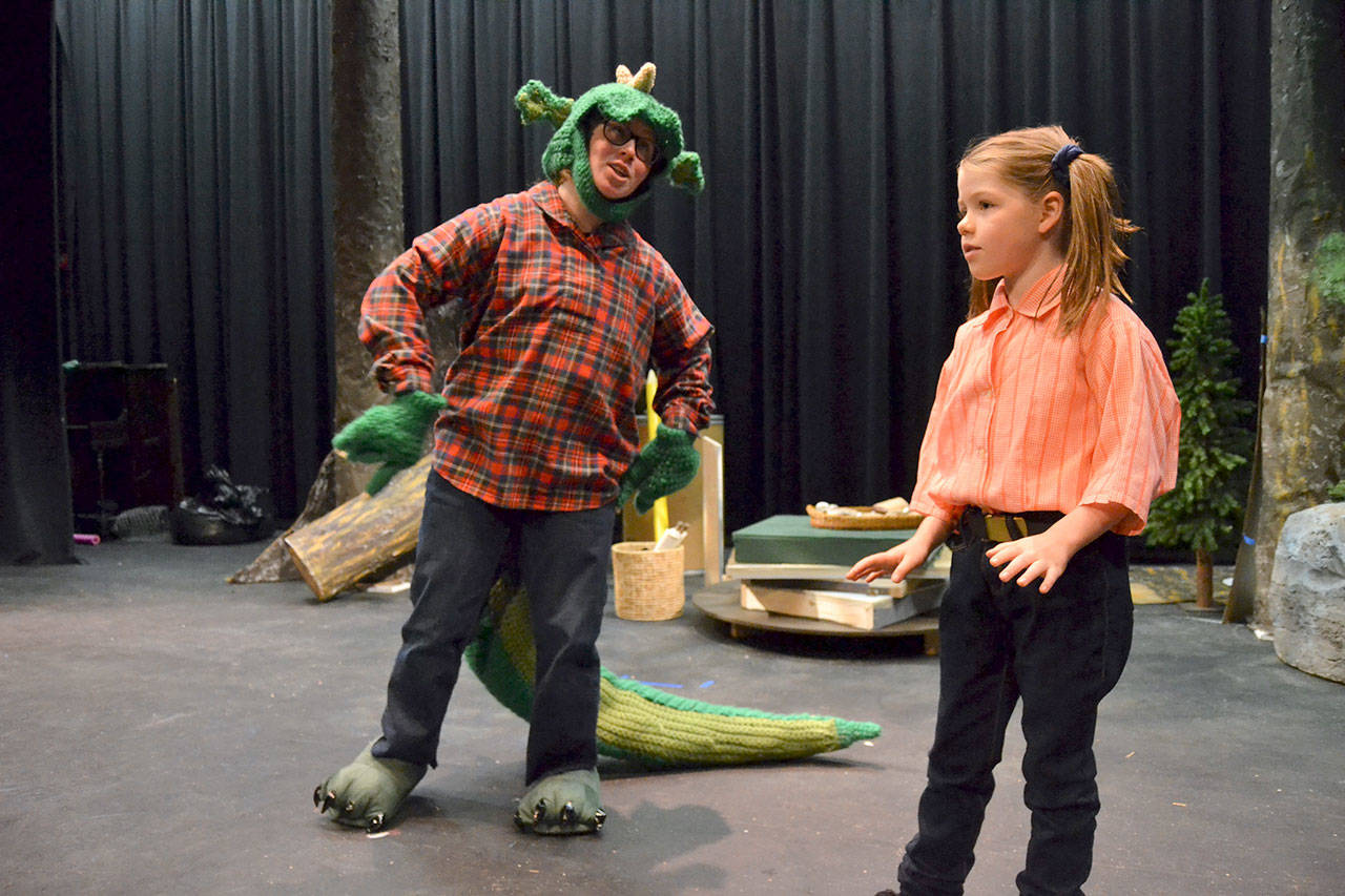 Fred the Dragon (Grayce Houle) talks to Charity (Maia Brewer) about how he’s not afraid of the town’s people and he’d rather eat snacks and write poetry in “The Reluctant Dragon.” Sequim Gazette photo by Matthew Nash