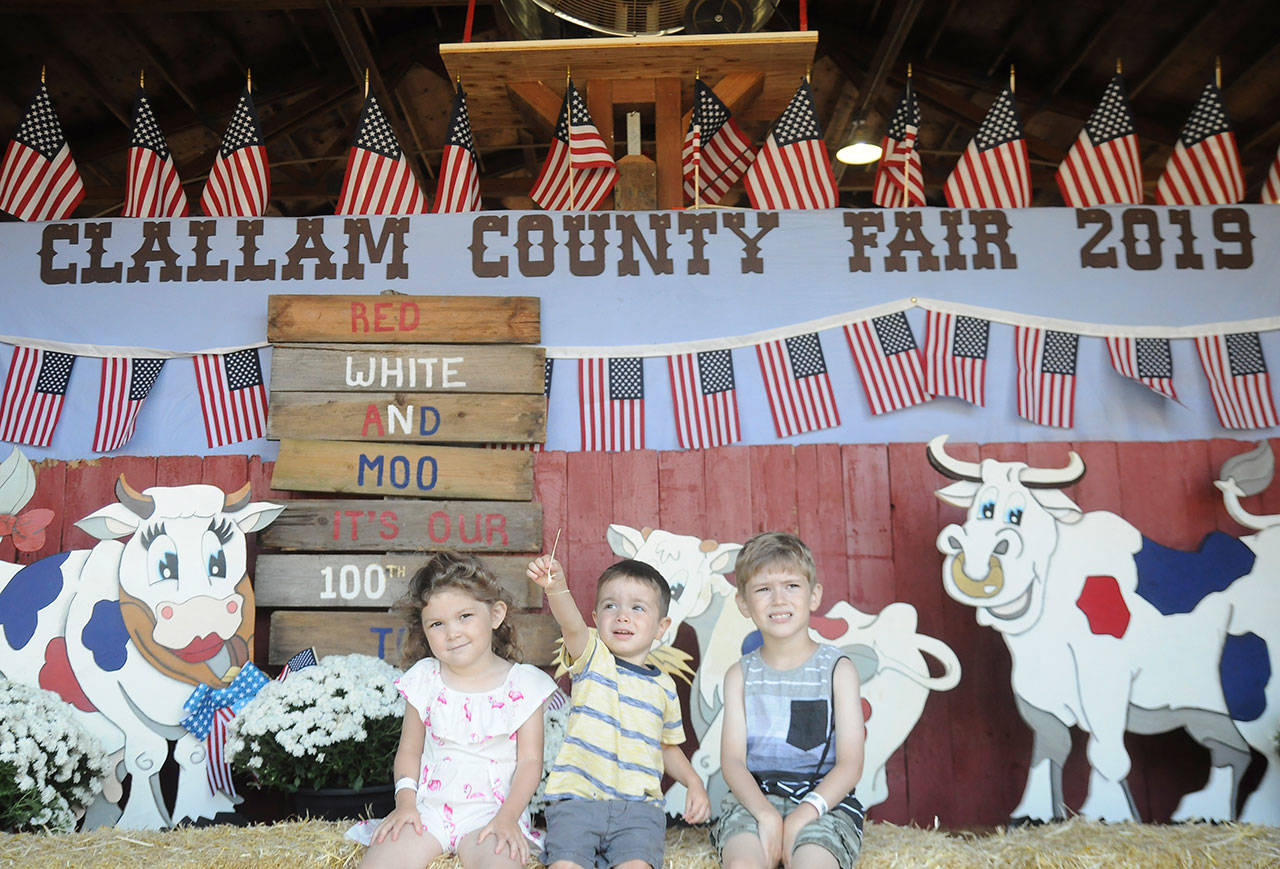 From left, Anabelle Stringham, 4, Nicky Hendrickson, 2, and Wyatt Stringham, 5, enjoy the first day of the Clallam County Fair on Aug. 14. The Stringhams are from Port Angeles; Hendrickson is from Forks. Sequim Gazette photo by Michael Dashiell