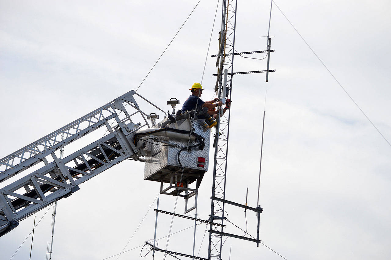 Fire officials add a 6-meter-tall radio antenna onto the radio mast on Aug. 20 to help with communications. Assistant Chief Dan Orr said the project has been in the works for a long time. Sequim Gazette photo by Matthew Nash