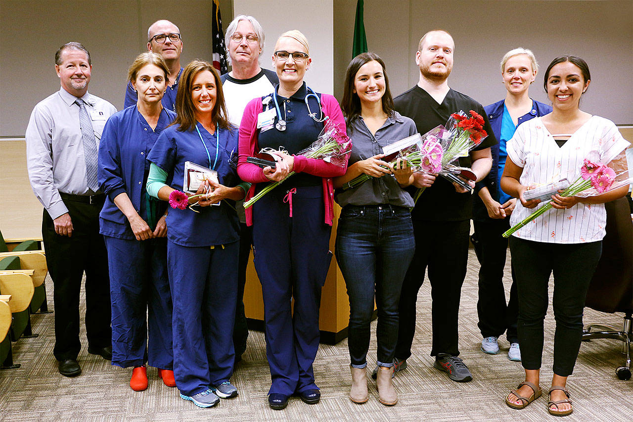 Pictured, from left, are: chief nursing officer Ralph Parker; Vickie Swanson, director of surgical services; certified surgical technologist Jim Ray; nurses Rachel Baar, Ken Reynolds, Cheryl Mingee and Megan Larrechea; certified nurse assistant Bret Hensley; Katrin Junghanns-Royack, director of intensive care/telemetry, and nurse Catalina Gonzalez. Not pictured is nurse Nan Mulholland. Photo courtesy of Olympic Medical Center