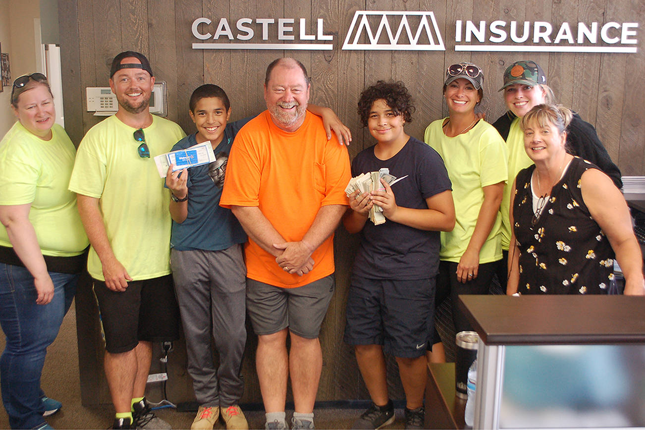 From left to right, Stephany Shackelford, James Castell, Malachi Williams, Phil Castell, Saul Williams, Kelsey Sands, Andrea Wellman and Christy Francis stand in the Castell Insurance office on Aug. 24 after their annual shred event concluded as the Williams brothers hold the money raised. The fundraiser that supports the Boys & Girls Club and their efforts to provide school supplies to students and families in need raised over $9,000 this year. Sequim Gazette photo by Conor Dowley