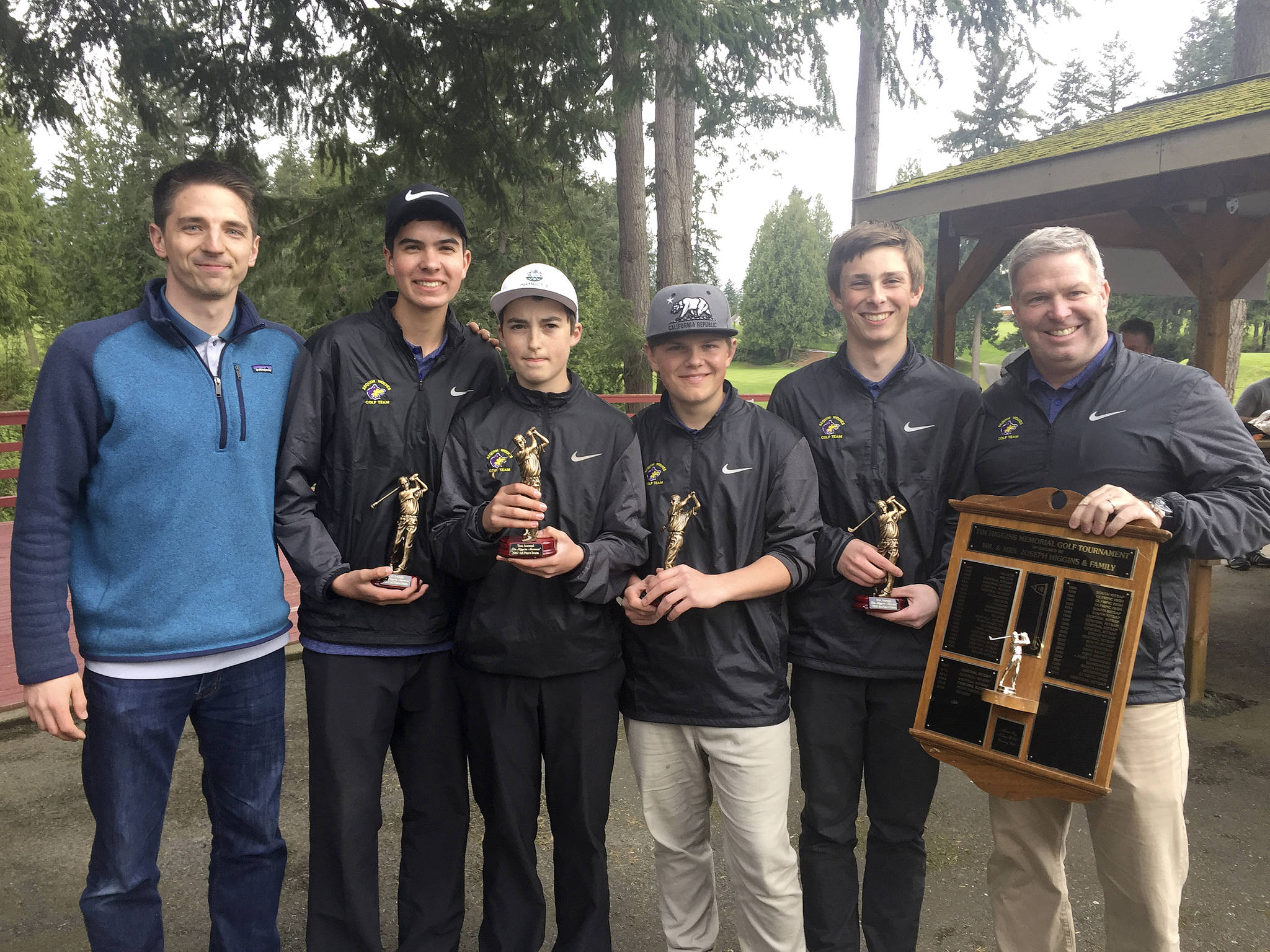 Under head coach Bill Shea (far right), the Sequim High School boys golf team celebrates defense of its title at the 51st annual Tim Higgins Memorial at Kitsap Golf and Country Club in Bremerton in 2017. Shea is stepping down from the coaching position this year after leading Sequim to four consecutive undefeated, Olympic League title-winning seasons. Pictured, from left, are assistant coach Sean O’Mera, Blake Wiker, Paul Jacobsen, Andrew Vanderberg, Josiah Carter and Shea. Submitted photo