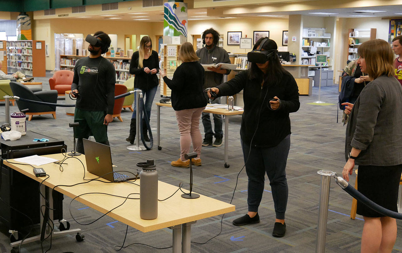 Patrons try out virtual reality (VR) devices at a recent VR session in Port Angeles. Photo courtesy of North Olympic Library System