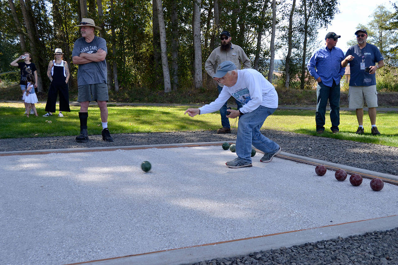 David Stahl rolls a bocce ball to help open play on the new court in Carrie Blake Community Park on Aug. 28. Sequim Gazette photo by Matthew Nash