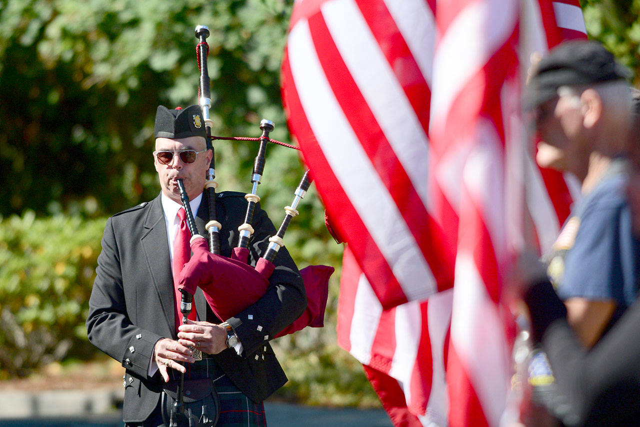 Rick McKenzie, a retired Coast Guard veteran, plays bagpipes at the 9/11 Memorial Waterfront Park during 2017 ceremonies. (Jesse Major/Peninsula Daily News)