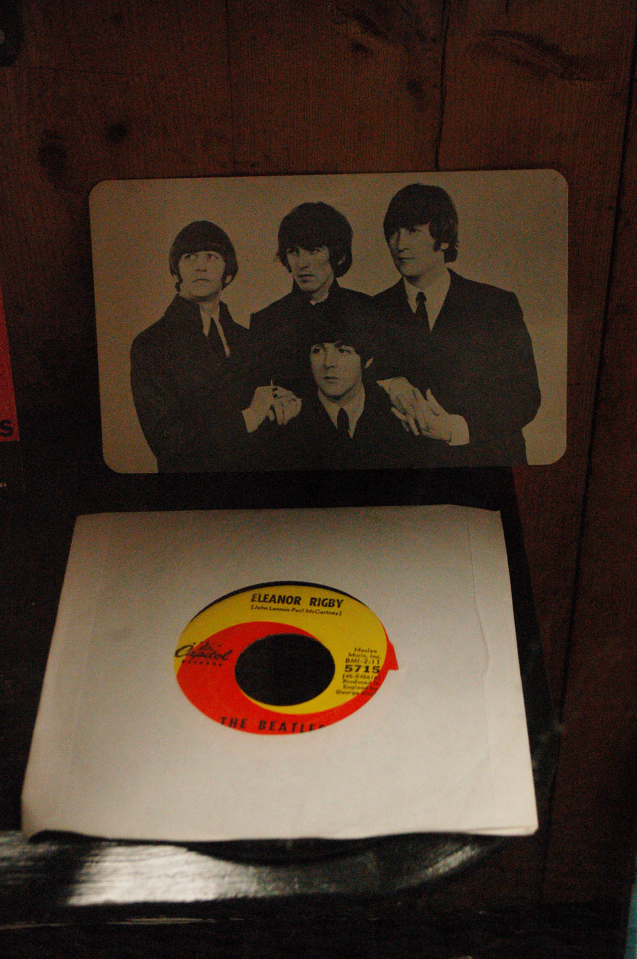 A vinyl single of Eleanor Rigby on display in the KSQM radio station community room along with a classic picture of The Beatles from the early days of the band. Collection owner George Dooley said that he saw “early on” that The Beatles were going to change things in the music industry. Sequim Gazette photo by Conor Dowley