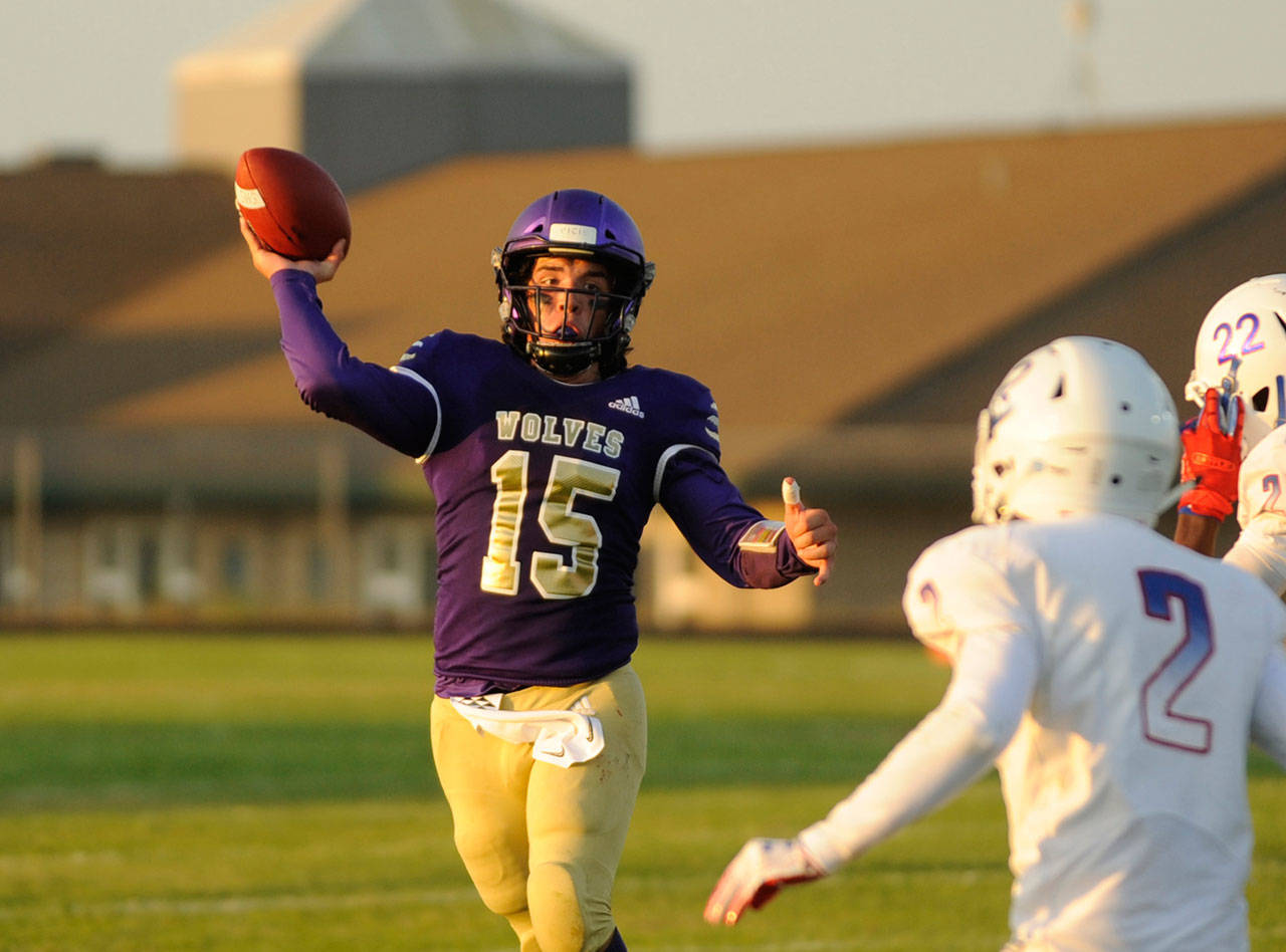Sequim High quarterback Taig Wiker looks for a two-point conversion in the second quarter of the Wolves’ match-up with Washington Sept. 6. Wiker connected with Hayden Eaton on the play for the conversion and a 28-0 Sequim lead. Sequim Gazette photo by Michael Dashiell