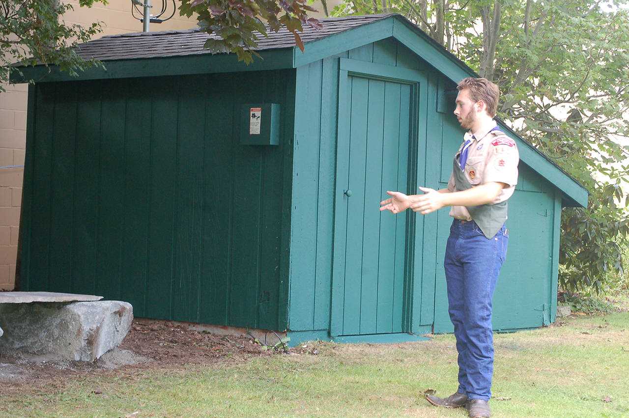 Ian Thill describes the work done to restore and enhance a storage shed at Pioneer Memorial Park for his Eagle Scout project. He said the job wound up being “much more work” than anticipated, with several additional structural elements of the shed getting replaced in addition to the planned roof replacement. Sequim Gazette photo by Conor Dowley