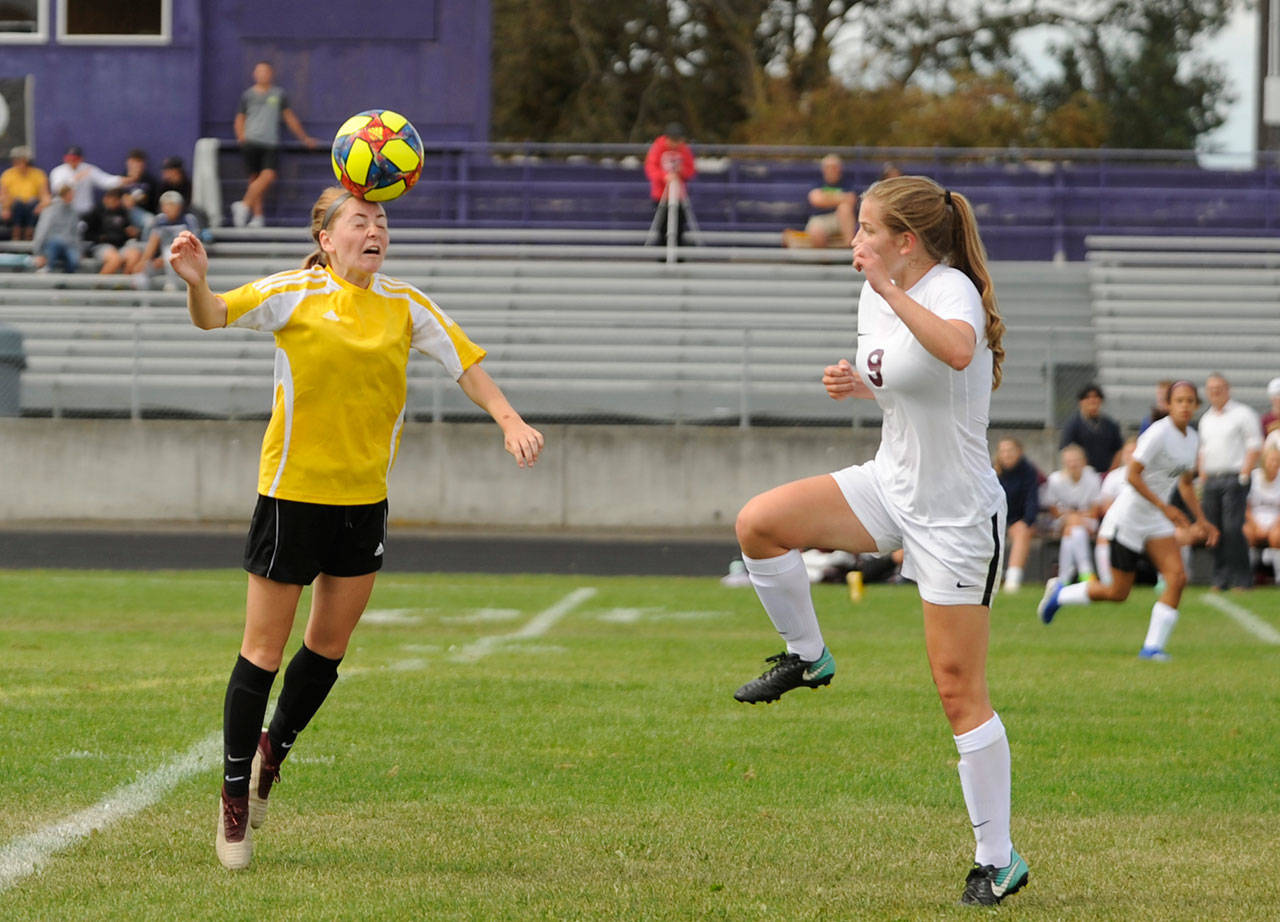 Sequim’s Daisy Ryan, left, heads a ball as the Wolves take on Lakewood in a non-league match to open the 2019 season on Sept. 7. The teams finished in a 1-1 draw; Ryan had the Wolves’ goal. Sequim Gazette photo by Michael Dashiell