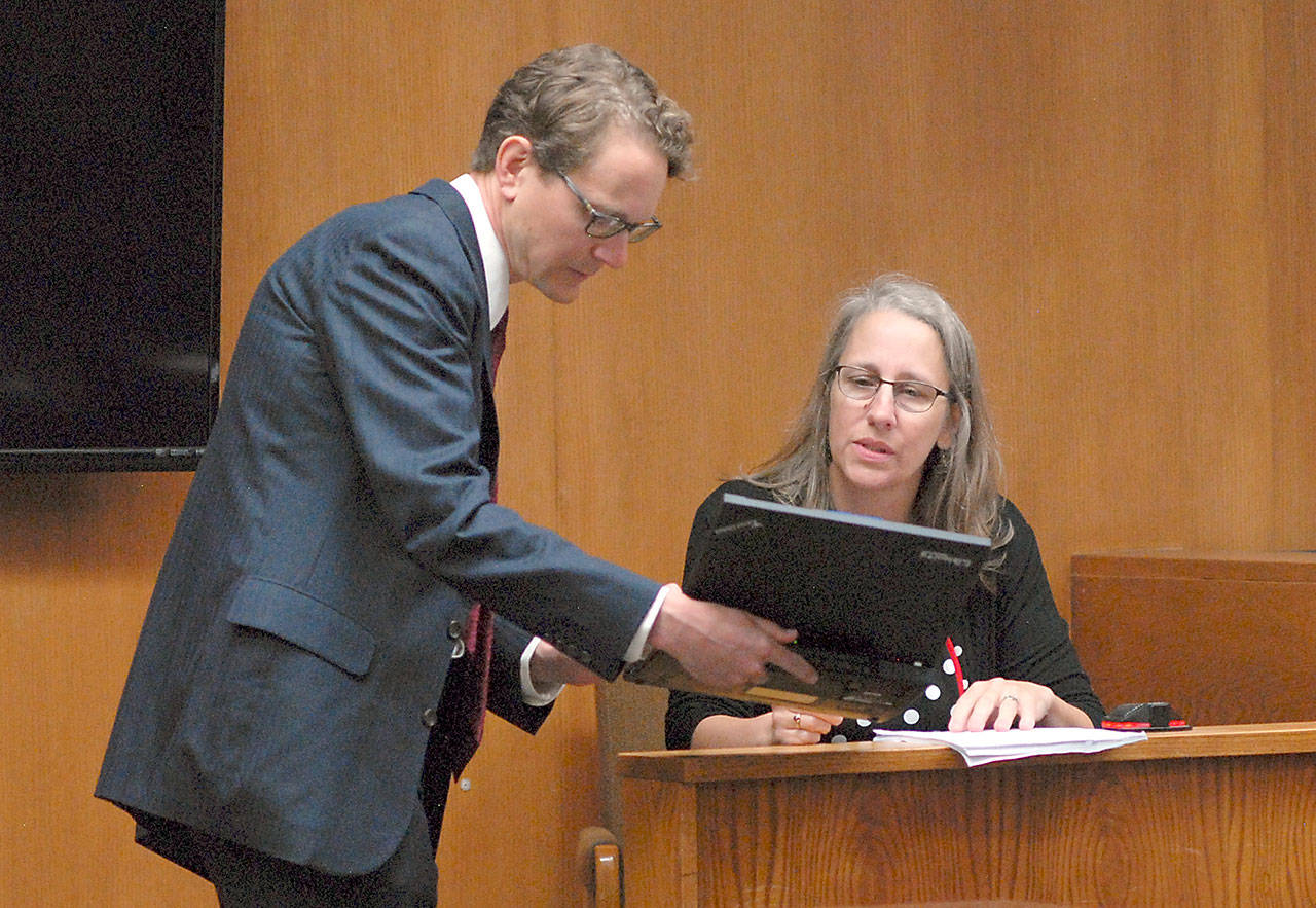 Ann Marie Henninger, a candidate for Olympic Medical Center Commissioner District No. 1, examines an electronic document displayed by Lindsey Schromen-Wawrin during cross-examination at Thursday’s Clallam County Superior Court hearing contesting Henninger’s eligibility for the position based upon her residency within the district. Photo by Keith Thorpe/Peninsula Daily News