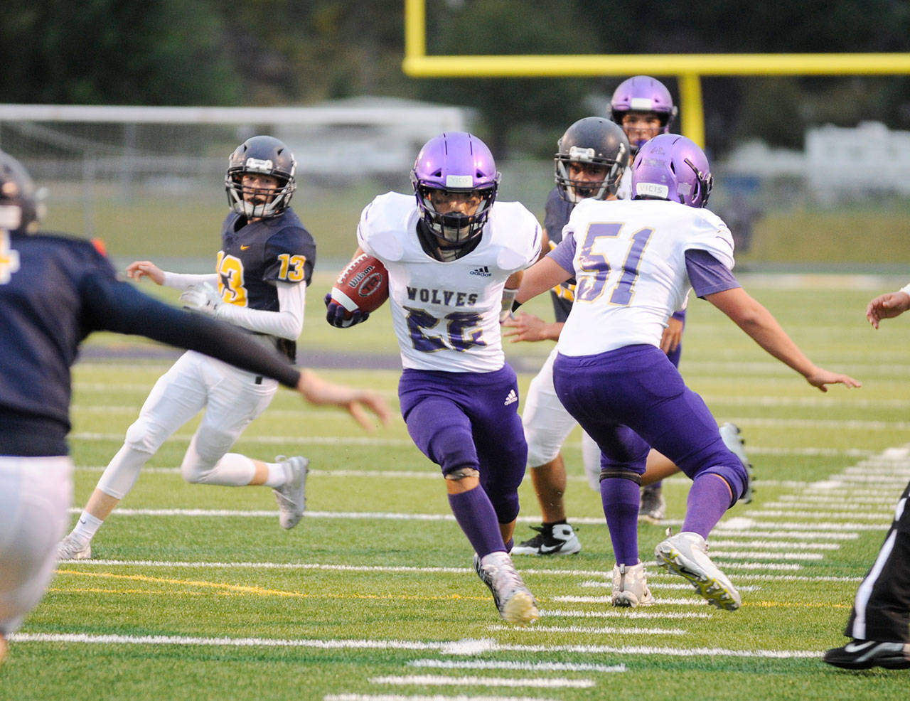 Sequim running back Walker Ward finds a gaping hole and bursts through for a big gain in the Wolves’ 27-13 win at Forks on Sept. 13. Ward finished with 160 yards on 31 carries. Sequim Gazette photo by Michael Dashiell