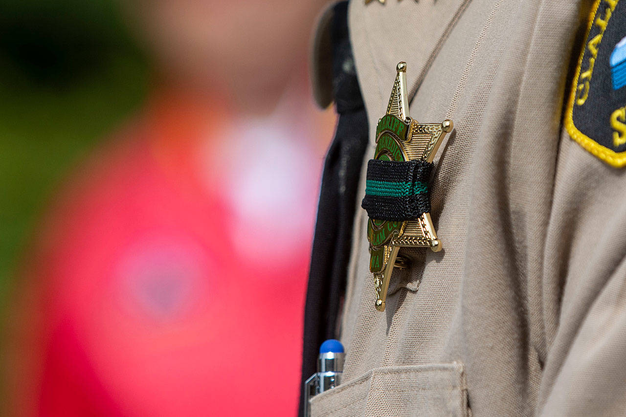 Clallam County Sheriff Bill Benedict wore a band over his badge during a ceremony in Port Angeles honoring public safety officials on the 18th anniversary of the 9/11 terrorist attacks Wednesday. (Jesse Major/Peninsula Daily News)