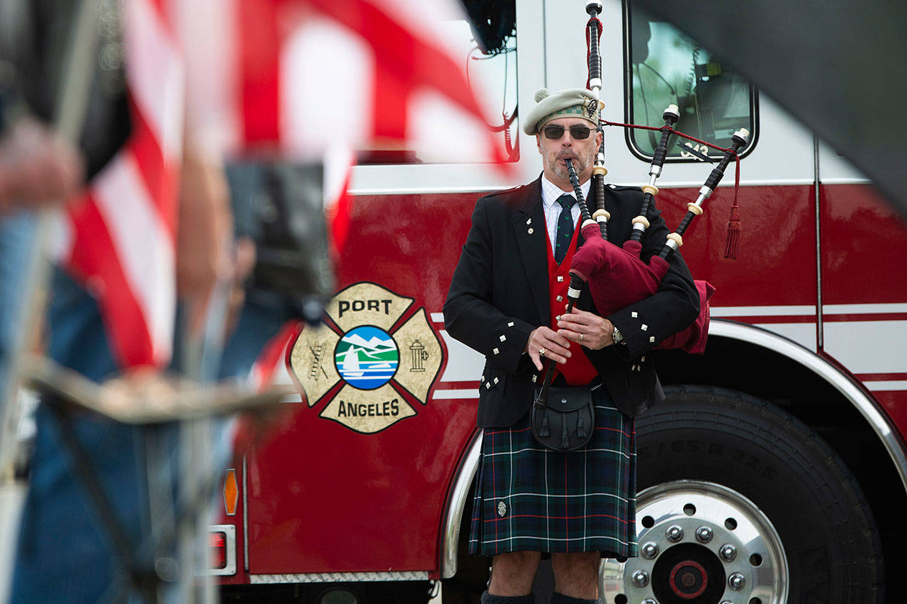 Retired Coast Guardsman Rick McKenzie plays bagpipes outside the Port Angeles Fire Department on the 18th anniversary of the 9/11 terrorist attacks Wednesday. (Jesse Major/Peninsula Daily News)