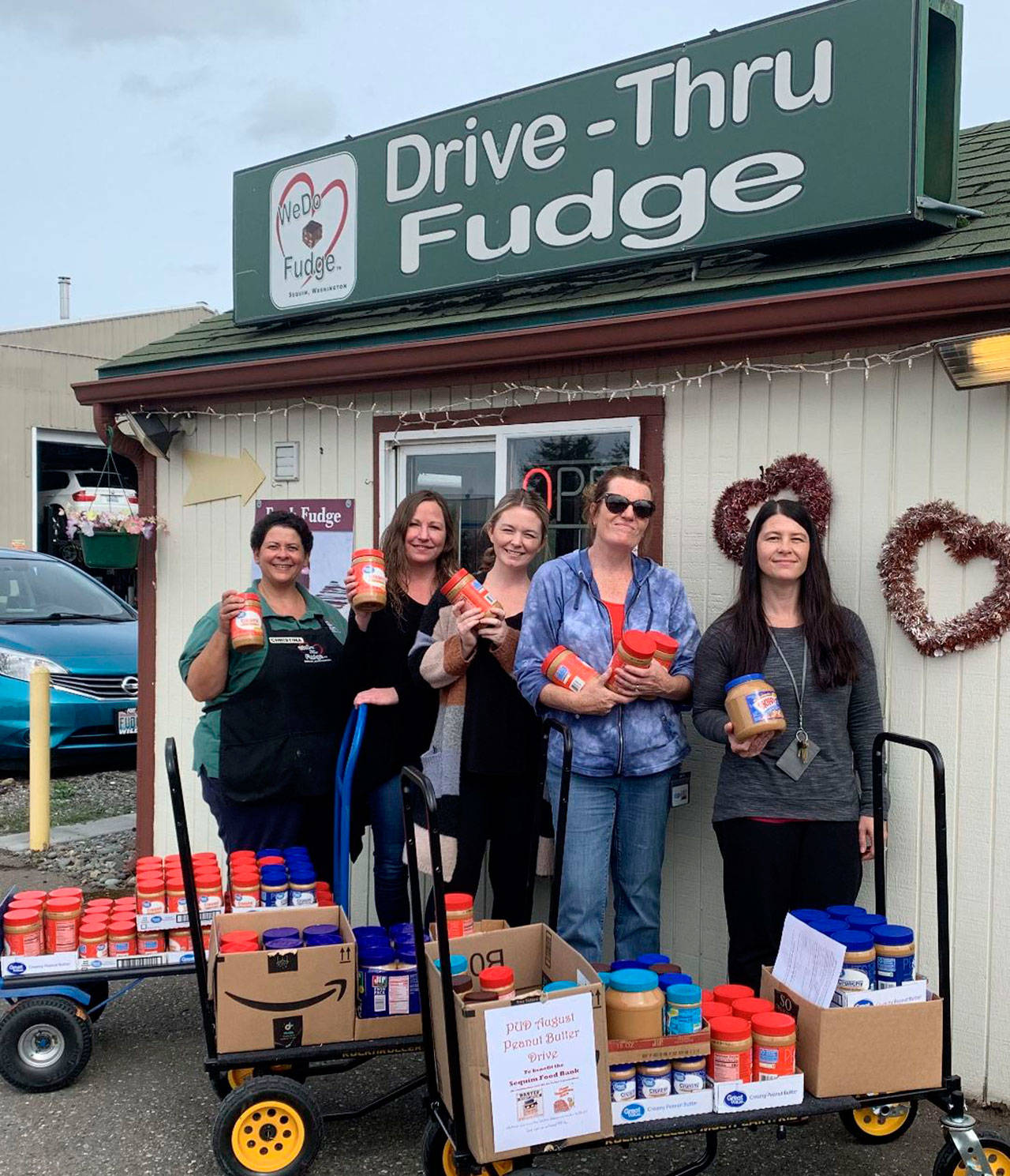 Employees of Clallam County PUD join Christina Norman of WeDo Fudge, far left, at the drive-thru’s annual peanut butter drive in August. Submitted photo