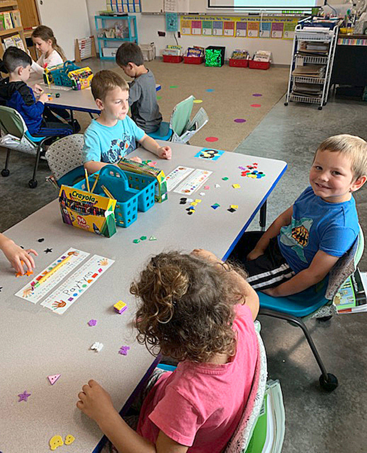 Kindergarten is in full swing at Greywolf Elementary. Here, Paytynn Lindley, Lucas Underwood and Isaac Robbins sort items during a math lesson. Photo by Carla Drescher