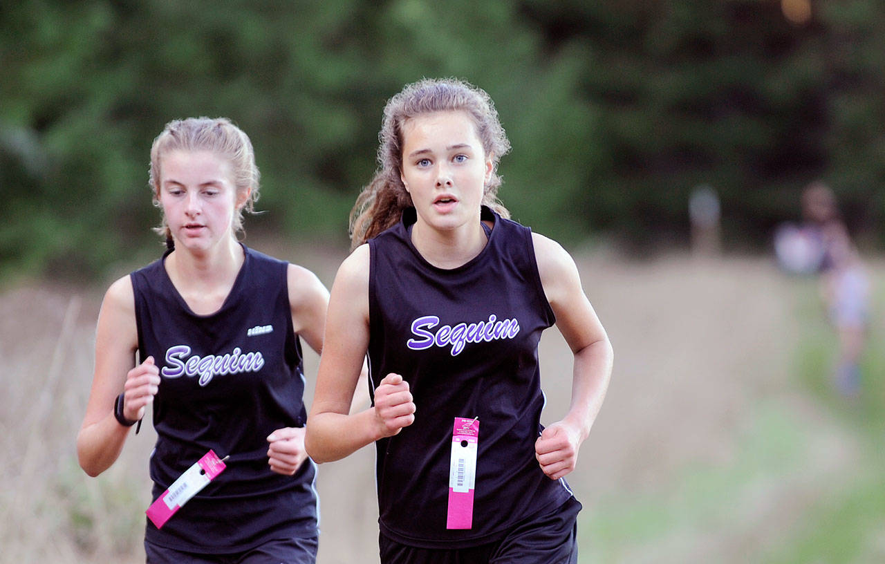 Sequim’s Jessica German, left, and Anastasia Updike race to the finish at the Sept. 18 Olympic League meet at Robin Hill County Park on Sept. 18. German, a junior, placed third overall in 25:12 while Updike, a freshman finished a second back in fourth place. Sequim’s girls edged Port Townsend by a point in the first league meet of the 2019 prep season. Sequim Gazette photo by Michael Dashiell