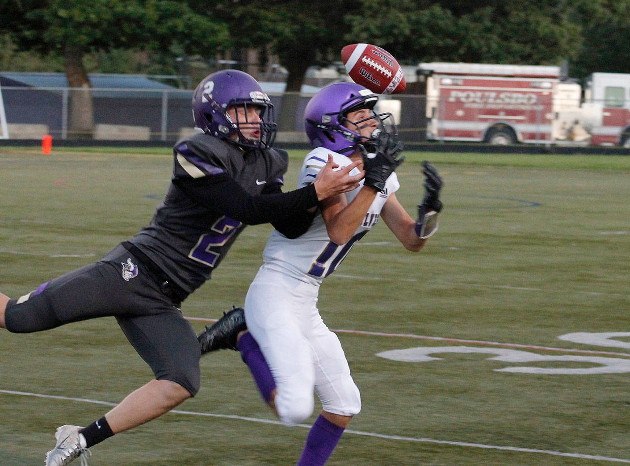 Garrett Hoesel tries to haul in a pass while holding off North Kitsap’s Colton Bower. Hoesel lead the Wolves in receptions with five catches for 56 yards. Photo courtesy of Mark Krulish/Olympic Peninsula Newsgroup
