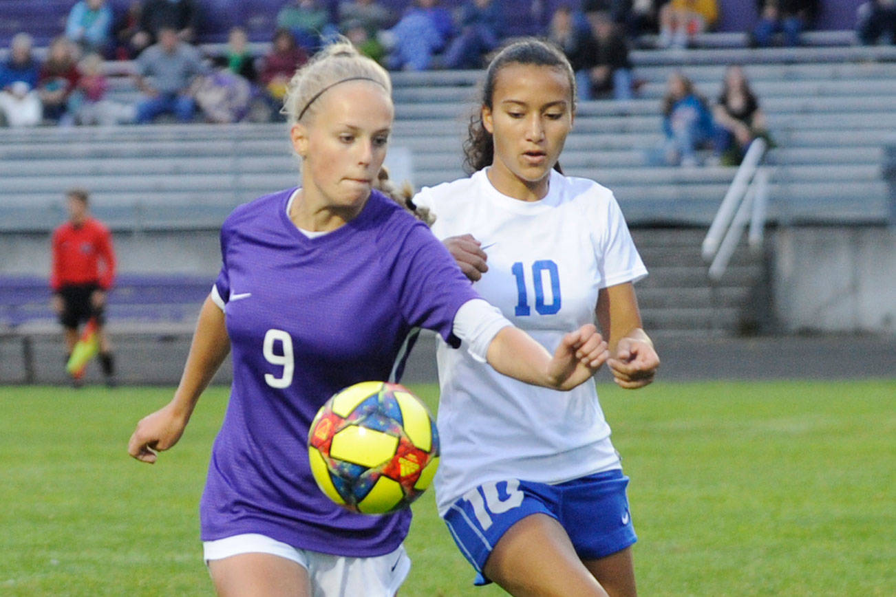 Sequim’s Eden Johnson, left, vies for the ball with Bremerton’s Neveah Jackman in an Olympic League match on Sept. 17. Sequim won, 4-1. Sequim Gazette photo by Michael Dashiell