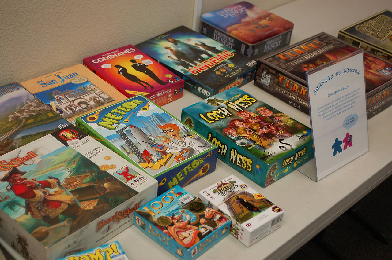 A selection of games available for anyone to play at a recent Meeples of Sequim gathering on Sept. 18. Travis Britten said that he and his wife Echo Cox try to bring a variety of games from week to week, and other regulars bring various games as well. Sequim Gazette photo by Conor Dowley