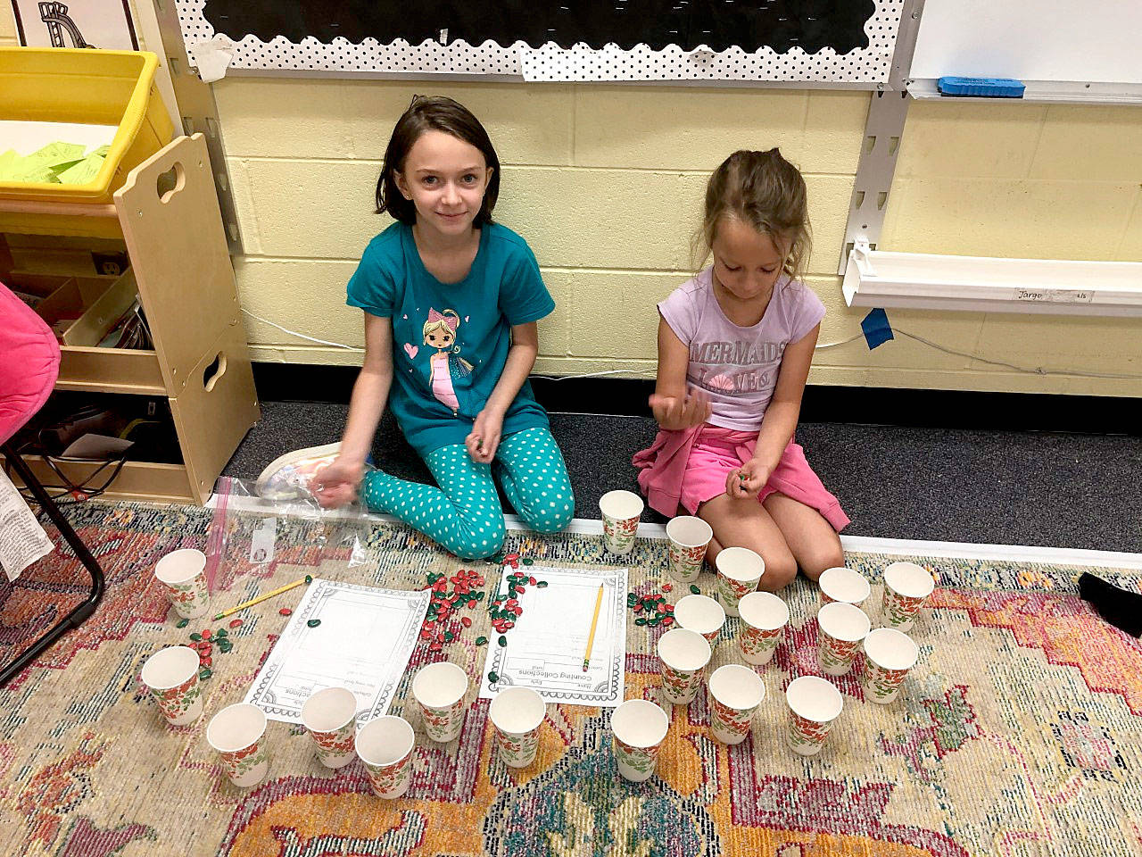 Elyssa Cunningham and Ellie Roedell, both second-graders in Doreen Minard’s class at Helen Haller Elementary School, use a math routine called “Counting Collections” as an introduction to learning about place value. Submitted photo