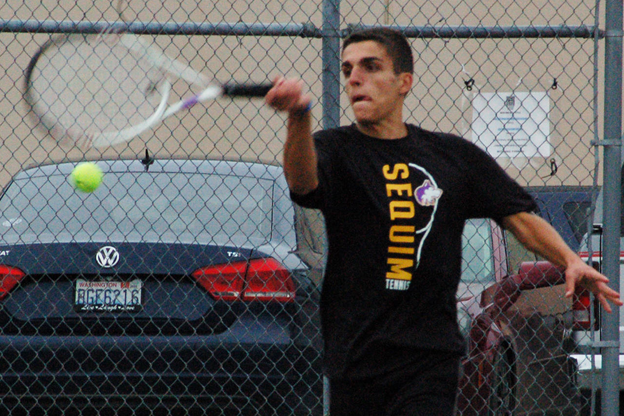Nico Zingaro returns a serve in the second set of his match against North Kitsap’s Chris Schuchart on Sept. 25, which he would win 6-2 to win the match. Zingaro was Sequim’s only undefeated player on the week, not dropping a single set in three matches. Sequim Gazette photo by Conor Dowley