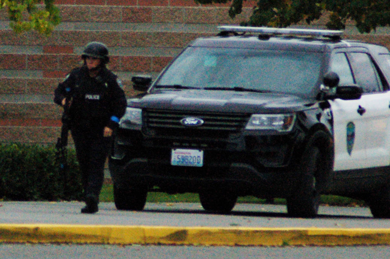 Officer Kindryn Leiter approaches Sequim Middle School during the Criminal Mass Casualty Incident drill on Sept. 28. Officers participating in the drill were not told of the exact location or situation of the incident within the school other than what would naturally come over dispatch, so as to force then to approach it with the kind of tactical thinking they’d employ in a live situation. Officers were also carrying training weapons and were checked before the drill to make sure they didn’t accidentally have live weapons. Sequim Gazette photo by Conor Dowley