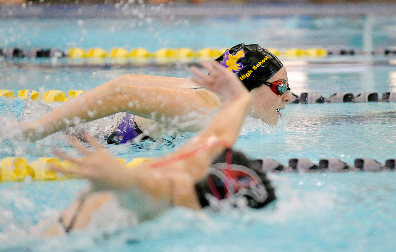 Lauren Sundin of Sequim, background, races to a 1:22 finish in the 100-yard butterfly, good for second place in the Wolves’ win over Port Townsend on Sept. 26. Sundin had two top-three swims against North Kitsap last week. Sequim Gazette photo by Michael Dashiell