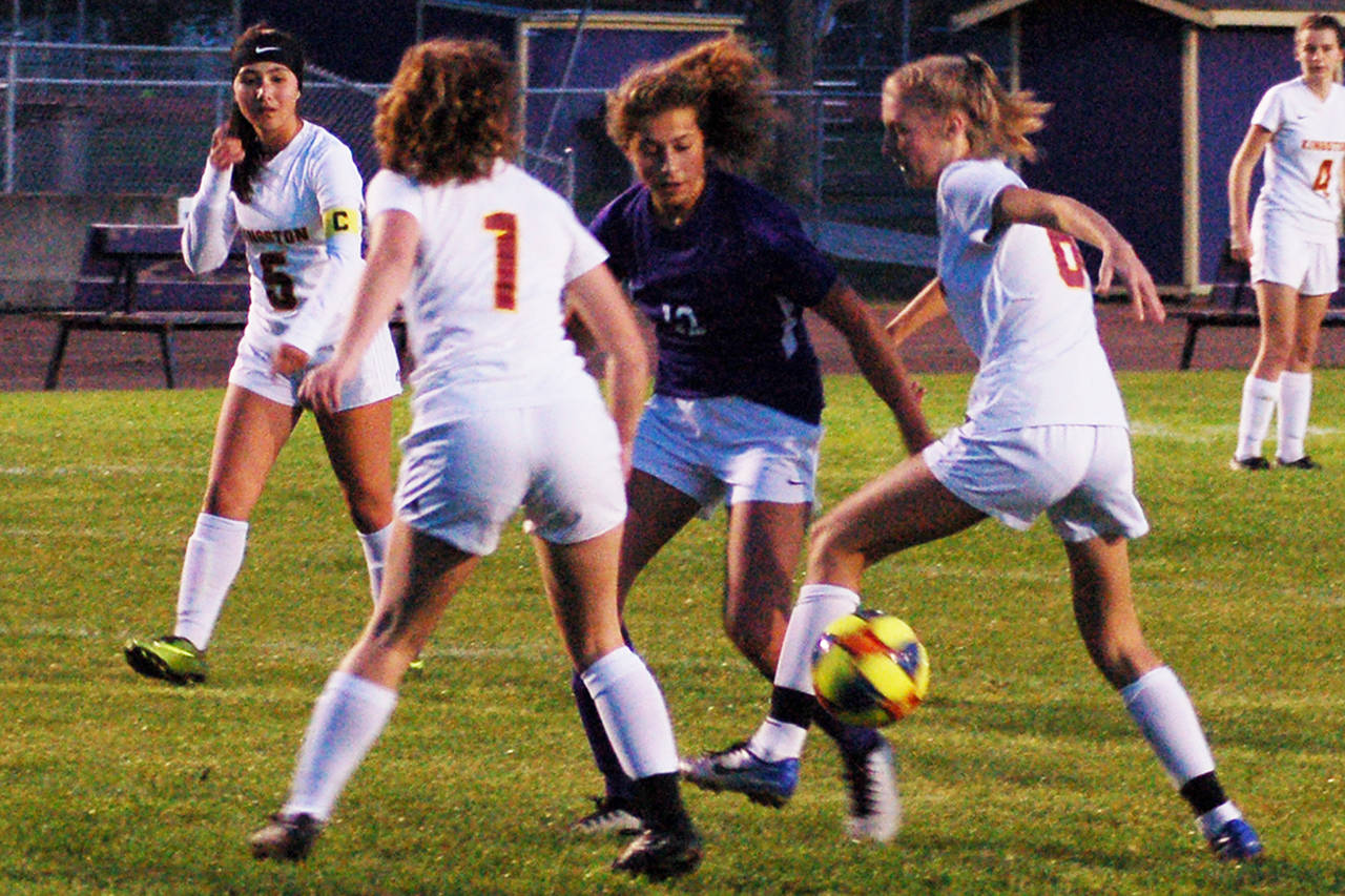Sequim Wolves senior midfielder Jessica Dietzman fights through two Kingston defenders while attempting to drive an attack closer to goal. Dietzman would score Sequim’s opening goal shortly after this in their 5-0 win over Kingston on Oct. 3. Sequim Gazette photo by Conor Dowley