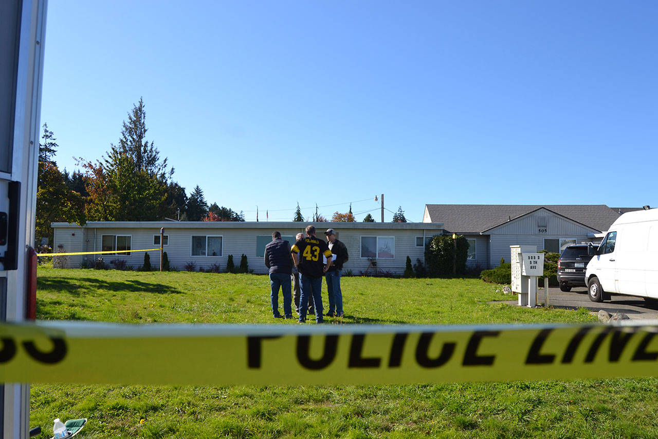 Detectives with the Olympic Peninsula Narcotics Enforcement Team (OPNET) talk outside of the Sunbelt Apartments on Oct. 9, the afternoon after a Sequim woman allegedly tried to kill a fellow resident in the complex. Sequim Gazette photo by Matthew Nash