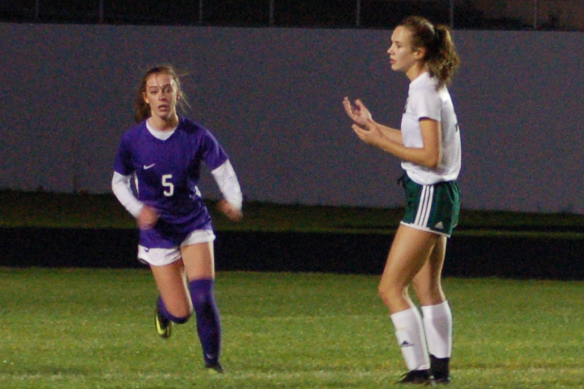 Port Angeles Roughriders forward Hannah Reetz (right) shows frustration after Mary McAleer (left, 5) clears a pass intended for her in front of the Sequim Wolves goal on Oct. 8. Reetz and star forward Millie Long struggled for quality service into the final third because of the Wolves’ game plan in their 2-1 shootout win. Sequim Gazette photo by Conor Dowley
