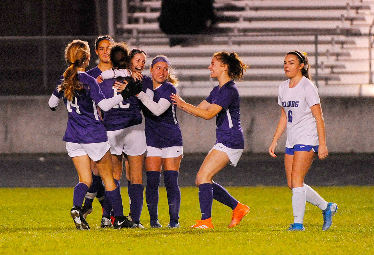 Sequim teammates celebrate Daisy Ryan’s second half-opening score against Olympic on Oct. 15. The Wolves edged the visiting Trojans 2-1 on penalty kicks. Sequim Gazette photo by Michael Dashiell