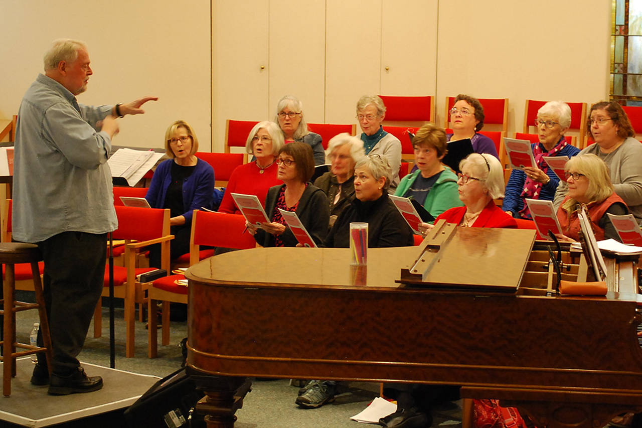 Jerome Wright, left, leads the Peninsula Singers in a rehearsal at Trinity United Methodist Church on Oct. 17. The Singers are preparing for their annual fall concert, with shows on Nov. 23 & 24, but are still recruiting more singers for all sections in the area who can read music. Sequim Gazette photo by Conor Dowley