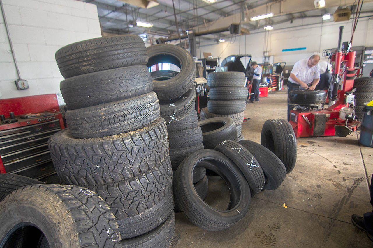 Tires punctured by screws sit at Les Schwab in Port Angeles. The State Patrol said Sunday that hundreds of screws were left on Highway 101 east of Port Angeles by accident after falling out of somebody’s vehicle. Photo by Jesse Major/Peninsula Daily News