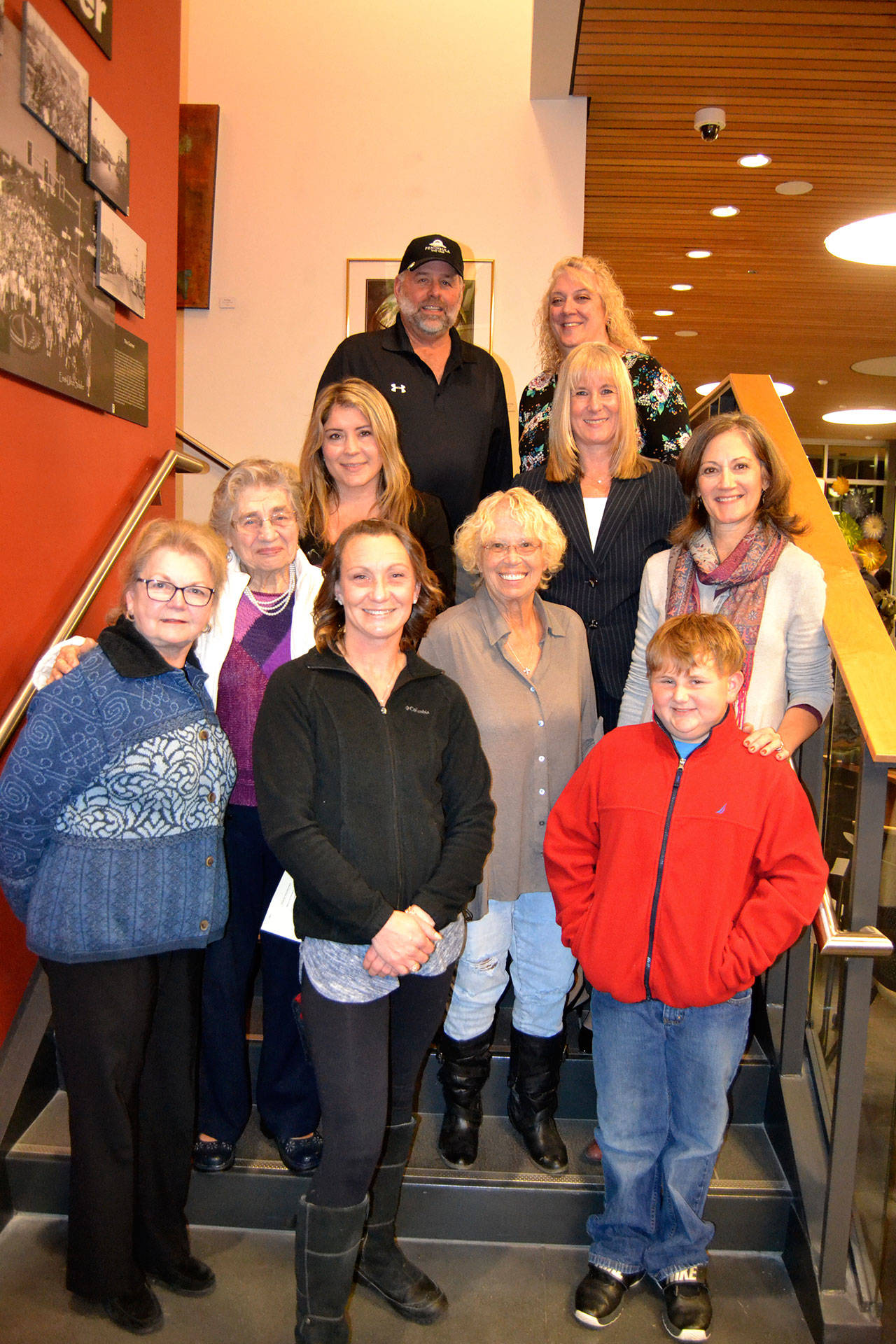 Family and friends gather to commemorate the Sequim Civic Center being named after longtime Sequim city clerk Karen Kuznek-Reese, who was unable to attend the occasion due to being in the hospital. There for the occasion were, top left, Robb Reese, husband, Paula Swisher, Washington Municipal Clerk’s Association (WMCA) president; second row, Carolyn Gallaway, Jefferson County deputy clerk, Virginia Olsen, WMCA immediate past president; third row, Helen Kuznek, mother, Mary Bower, retired Clallam Transit clerk, Joanna Sanders, City of Port Townsend clerk; bottom row, Sharon DelaBarre, past chairman City Arts Advisory Commission, Alicia Neal, daughter, and Brody Neal, grandson. Sequim Gazette photo by Matthew Nash