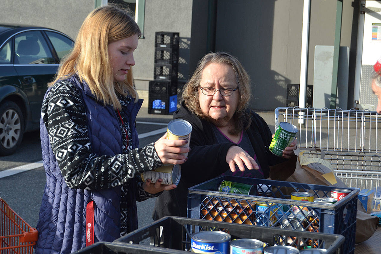 JoNell Hill, coordinator of the Boo Hunger food drive, chats with Lelia Nichols with Trinity United Methodist Church as they sort food on Halloween morning. Locals donated about 4,500 pounds of food this year. Sequim Gazette photos by Matthew Nash